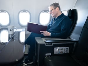 Prime Minister Sir Keir Starmer works on board a Government plane as he travels to Rio de Janeiro