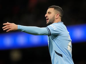 Manchester City right-back Kyle Walker gestures with his left arm during a match