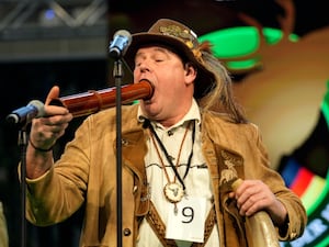 Immo Ortlepp performs to imitate a stag in heat during the German Championship of Deer-Calling at the hunting fair in Dortmund, German