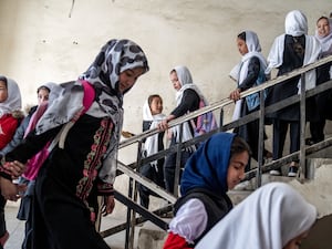 A group of girls walking down stairs