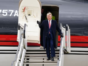 Donald Trump on the steps of a plane