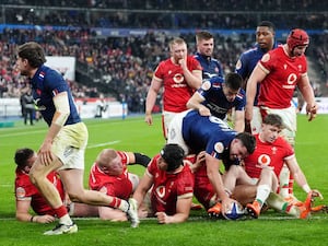 France’s Julien Marchand dives over a group of Wales players to score a try