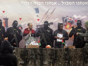 Israeli hostages Tal Shoham, left, and Avera Mengisto escorted by Hamas fighters