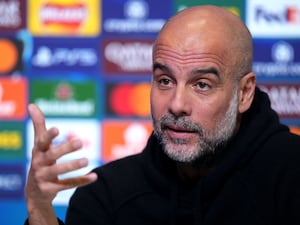 Pep Guardiola gestures with his hand during a press conference