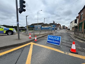 A police car and road closed sign