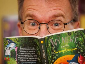 Derek Keilty's eyes peering out above one of his Ivy Newt books