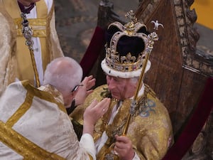 The Archbishop of Canterbury lowers the St Edward's Crown onto the King's head (Aaron Chown/PA)