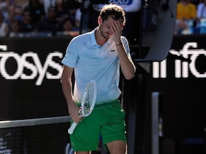 Daniil Medvedev holds his head in his hand