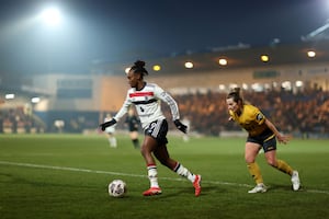 Melvine Malard of Manchester United runs with the ball under pressure from Becky Anderson of Wolverhampton Wanderers (Photo by Naomi Baker/Getty Images)