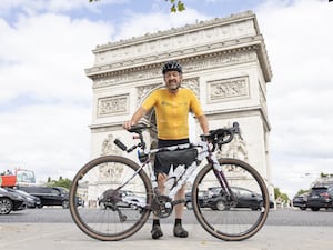 Chris Boardman with his bike in front of the Arc de Triomphe in Paris