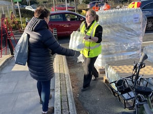 A resident collects water at bottle station at Asda, Totton