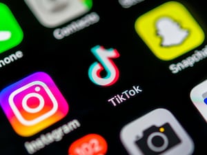 TikTok app icon on display of mobile phone