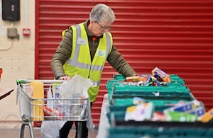 Carol McCann helps to pack one of the parcels for the Well