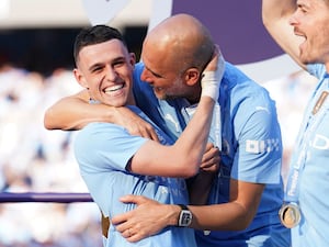 Pep Guardiola celebrating with Phil Foden