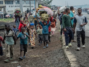 People displaced by the fighting with M23 rebels make their way to the centre of Goma in the Democratic Republic of Congo