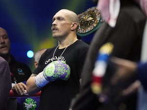 Oleksandr Usyk puts his hand to his chest