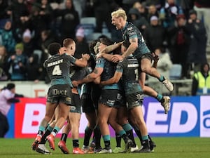 Gareth O’Brien (hidden) celebrates with team-mates after the game-winning drop-goal