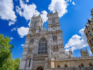 A view of Westminster Abbey on a sunny day with a bright blue sky