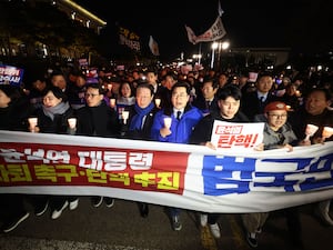 Protesters hold signs