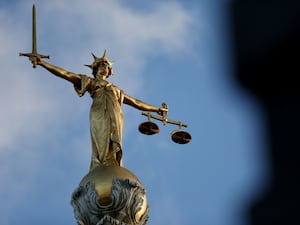 view of the Statue of Justice atop the Old Bailey