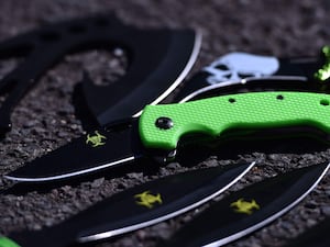 A zombie knife with a luminous green handle