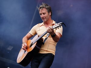 Chesney Hawkes playing guitar on stage