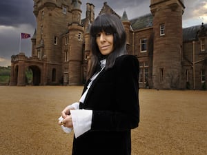 Claudia Winkleman in front of the castle where the Traitors is filmed