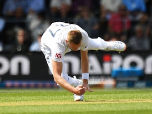 England’s Gus Atkinson takes a catch off his own bowling to dismiss New Zealand’s Devon Conway