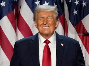 Donald Trump with US flags backdrop