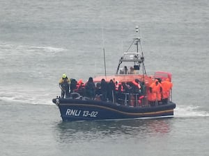 The Dungeness Lifeboat brings a group of people into Dover.