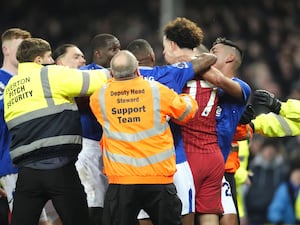 Liverpool’s Curtis Jones, right, and Everton’s Abdoulaye Doucoure are separated by team-mates and members of the ground staff after the final whistle in the Premier League derby at Goodison Park