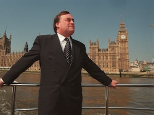 John Prescott poses in front of the Houses of Parliament during his term as deputy prime minister