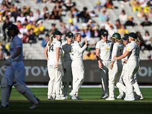 Ashleigh Gardner of Australia, center, celebrates with teammates after taking the wicket of England’s Amy Jones, left,