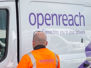 An Openreach engineer next to a company van