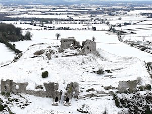 People walk in the snow at the Rock of Dunamase in Co Laois in Ireland