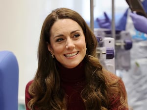 The Princess of Wales smiles as she sits and chat with fellow patients