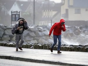 People struggle to walk in strong winds in Northern Ireland