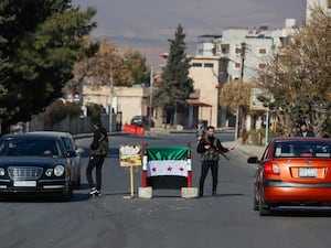 Syrian opposition fighters man a checkpoint in Damascus, Syria