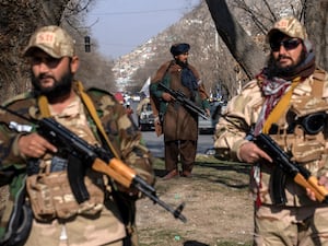 Taliban fighters stand guard in Kabul, Afghanistan