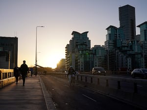 Commuters walk along Vauxhall Bridge, London