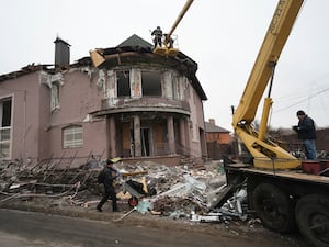 Rescue workers clear the rubble of a building damaged by a Russian strike on a residential neighbourhood in Zaporizhzhia