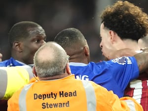 Everton's Abdoulaye Doucoure and Liverpool’s Curtis Jones are separated by stewards