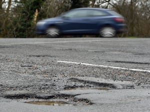 A car near a pothole