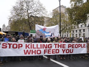 Farmers' protest in London with banner reading 'Stop killing the people who feed you'