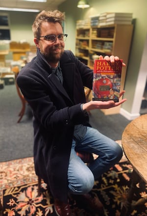 Jim Spencer, director of Rare Book Auctions, with Katie's pristine hardback first edition of Harry Potter and the Philosopher's stone. Photo: Rare Book Auctions