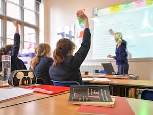 Pupils and a teacher in class