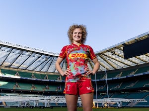 Rugby player Ellie Kildunne poses in her Harlequins kit at Twickenham Stadium