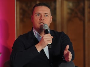 Health Secretary Wes Streeting holding a microphone