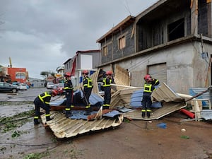 Rescue workers clear an area in the French territory of Mayotte in the Indian Ocean, after Cyclone Chido caused extensive damage with reports of several fatalities