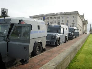 Police prepare to leave Stormont after a raid on the Sinn Fein office in 2002